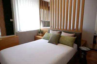a bedroom with a bed with pillows and a window at Porto Family Home by MP - Renovated in Porto
