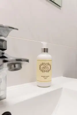 a bottle of soap sitting on top of a sink at Porto Family Home by MP - Renovated in Porto