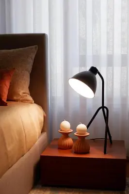 a lamp on a wooden table next to a bed at Porto Family Home by MP - Renovated in Porto