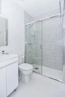 a white bathroom with a shower and a toilet at Fontinha Square Apartments by Porto City Hosts in Porto
