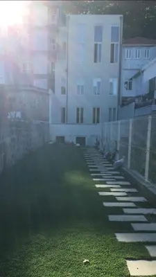 a building with a grassy yard next to a building at Oasis in Porto by SpiritBnb in Porto