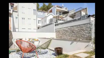 a group of chairs sitting on a patio in front of a building at Oasis in Porto by SpiritBnb in Porto
