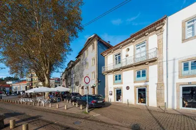 a street in a town with buildings and cars at Duplex Douro River in Porto