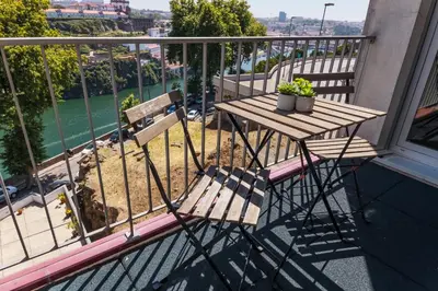 a wooden table and chair on a balcony at Porto Cathedral II in Porto