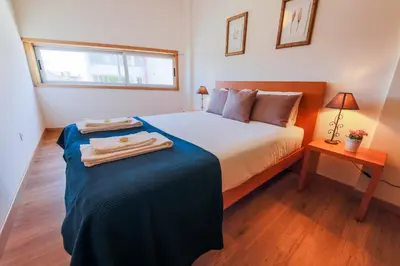 a bedroom with a bed with two towels on it at Porto Cathedral II in Porto