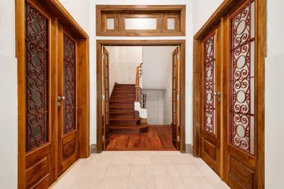 an open hallway with wooden doors and stairs at Bombarda Homes in Porto