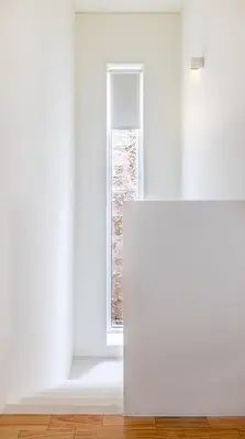 an empty room with a white wall and a window at Bombarda Homes in Porto