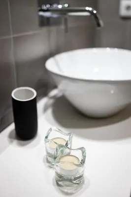 a bathroom with a sink and a cup and a bowl at Solar Studio Fontainhas in Porto