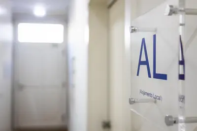 a sign for a door in a hospital hallway at Solar Studio Fontainhas in Porto