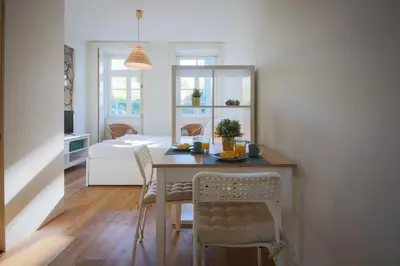 a dining room with a table and chairs at Solar Studio Fontainhas in Porto