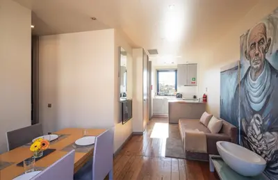 a living room with a dining table and a couch at 118 Oporto Apartments in Porto