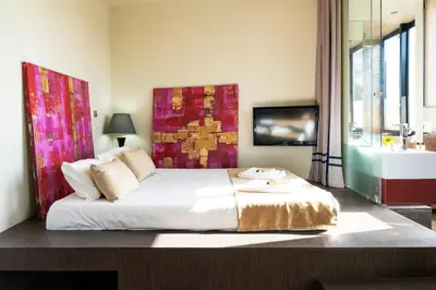 a bedroom with a large bed and a tv at 118 Oporto Apartments in Porto