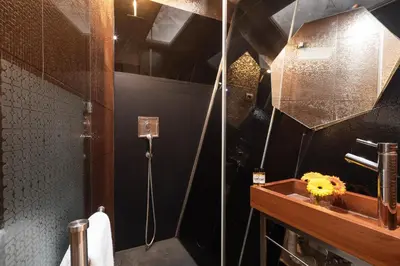 a bathroom with a shower and a sink with a flower at 118 Oporto Apartments in Porto