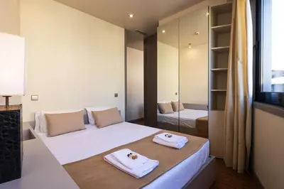 a bedroom with two beds and a mirror at 118 Oporto Apartments in Porto