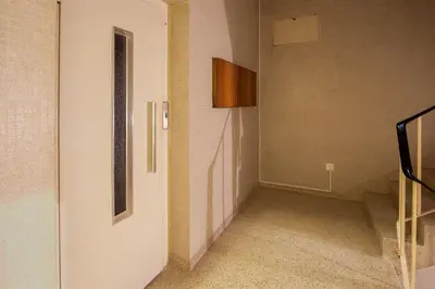 a hallway with a white door and a staircase at Cedofeita Studio 176 - Studio in city center in Porto