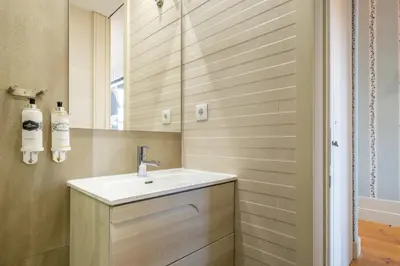 a kitchen with white cabinets and a dining room at Luxury House Downtown Porto in Porto