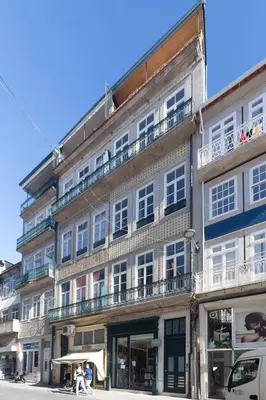 a tall building with people walking in front of it at Luxury House Downtown Porto in Porto
