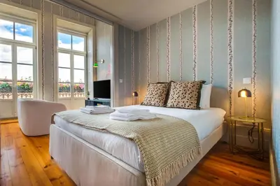 a living room with a white couch and a loft bed at Luxury House Downtown Porto in Porto