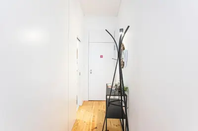a room with a floor lamp and a chair at Sunset Flat Santa Catarina in Porto