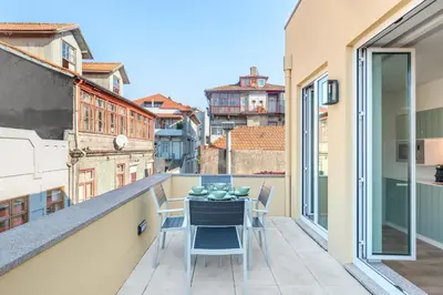 a balcony with a table and chairs on a balcony at 7 Bridges Estúdios- Porto-houses and suites in Porto