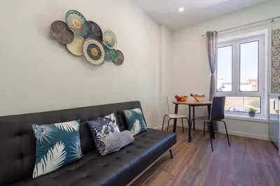 a living room with a couch and a table at OportoHost Dragão Duplex in Porto