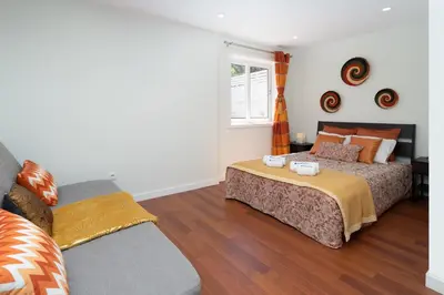 a bedroom with a bed and a window at OportoHost Dragão Duplex in Porto
