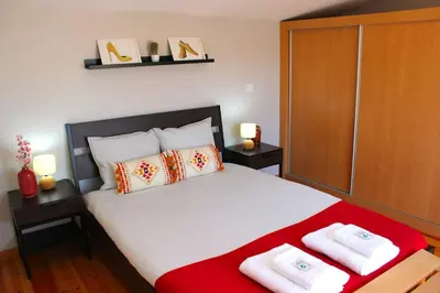 a bedroom with a large bed with two towels on it at OportoHost Campanhã in Porto