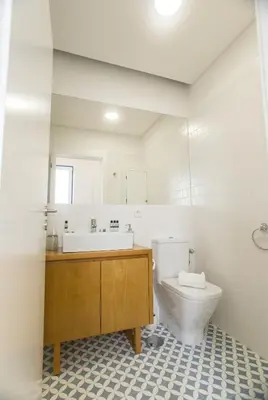a white bathroom with a sink and a toilet at Janelas de São Bento 3 by Porto City Hosts in Porto