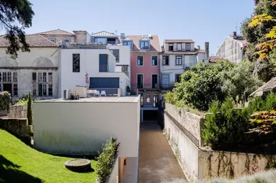a view from the garden of a house at BOUTIQUE Rentals- Art & Charm Apt w/ balcony & garage in Porto
