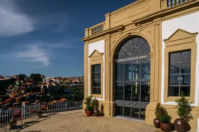 a dining room with a table and chairs and a potted plant at Vincci Ponte de Ferro in Vila Nova de Gaia