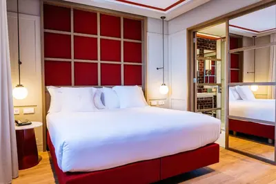 a bedroom with a large bed with a red headboard at Vincci Ponte de Ferro in Vila Nova de Gaia