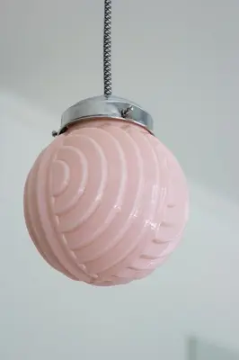 a pink glass pendant light hanging from a ceiling at Charming Camões Apartment in Porto with AC & Wi-Fi in Porto
