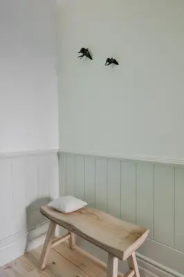 a wooden bench in a room with a wall at Charming Camões Apartment in Porto with AC & Wi-Fi in Porto