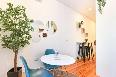 a kitchen with white cabinets and a counter at ON Apartments - Garden View in Porto
