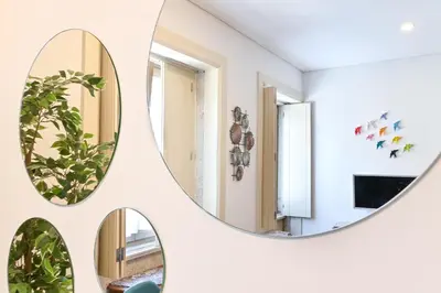 a bedroom with a bed and a painting on the wall at ON Apartments - Garden View in Porto
