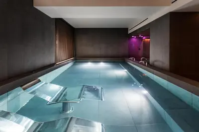 a large swimming pool in a large room with at Eurostars Aliados in Porto