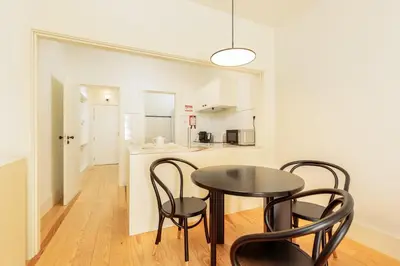 a table and chairs in a room with a kitchen at YOUROPO - Flores in Porto