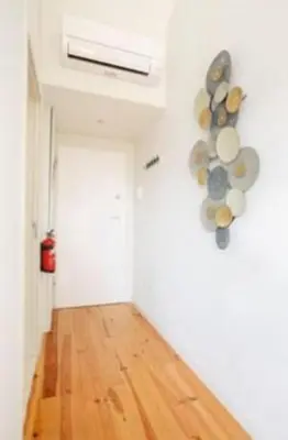 a room with a white wall with plates on the wall at Porto Pool Spot in Porto