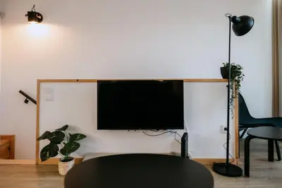 a living room with a flat screen tv on a wall at Villa Teresa apartamentos in Vila Nova de Gaia