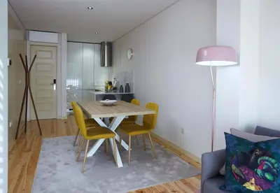 a kitchen and dining room with a table and chairs at ChillHouse_Porto - Praça da República in Porto