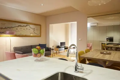 a kitchen and living room with a sink and a table at ChillHouse_Porto - Praça da República in Porto