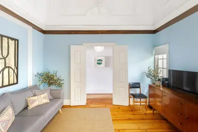 a living room with a couch and a tv at Charming Historic 31 Janeiro Street in Porto