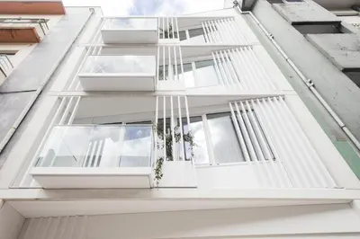 a facade of a white building with windows at Nomad's Easy Stay - 1BED Porto Marquês in Porto