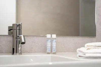 a bathroom sink with a mirror and two toothbrushes at Nomad's Easy Stay - 1BED Porto Marquês in Porto