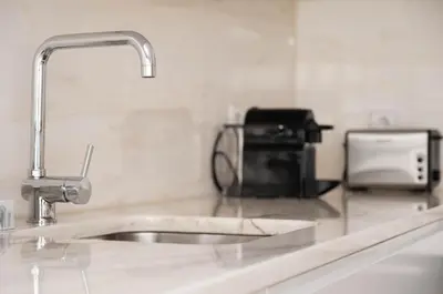 a kitchen counter with a sink and a appliance at Nomad's Easy Stay - 1BED Porto Marquês in Porto