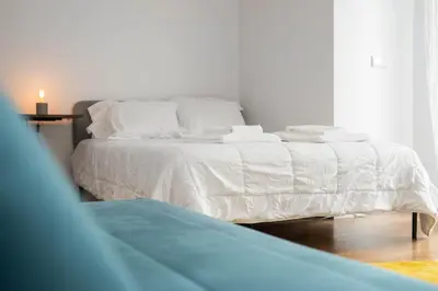 a white bed in a room with a window at Nomad's Easy Stay - 1BED Porto Marquês in Porto