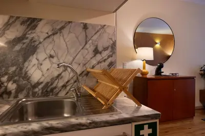 a kitchen with a sink and a mirror at Bolhão Apartment in Porto