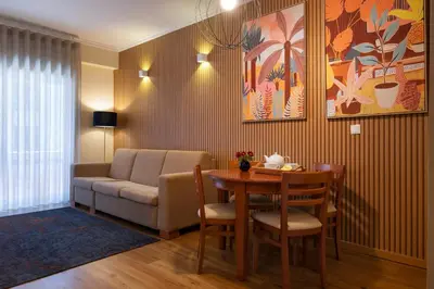 a living room with a table and a couch at Bolhão Apartment in Porto