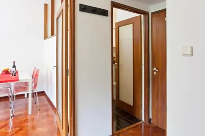 a door leading into a dining room with a table at O´Porto Torrinha Flat in Porto