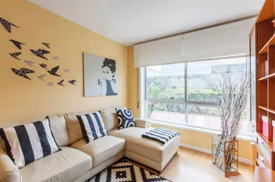 a living room with a white couch and a window at O´Porto Fontinha Flat in Porto